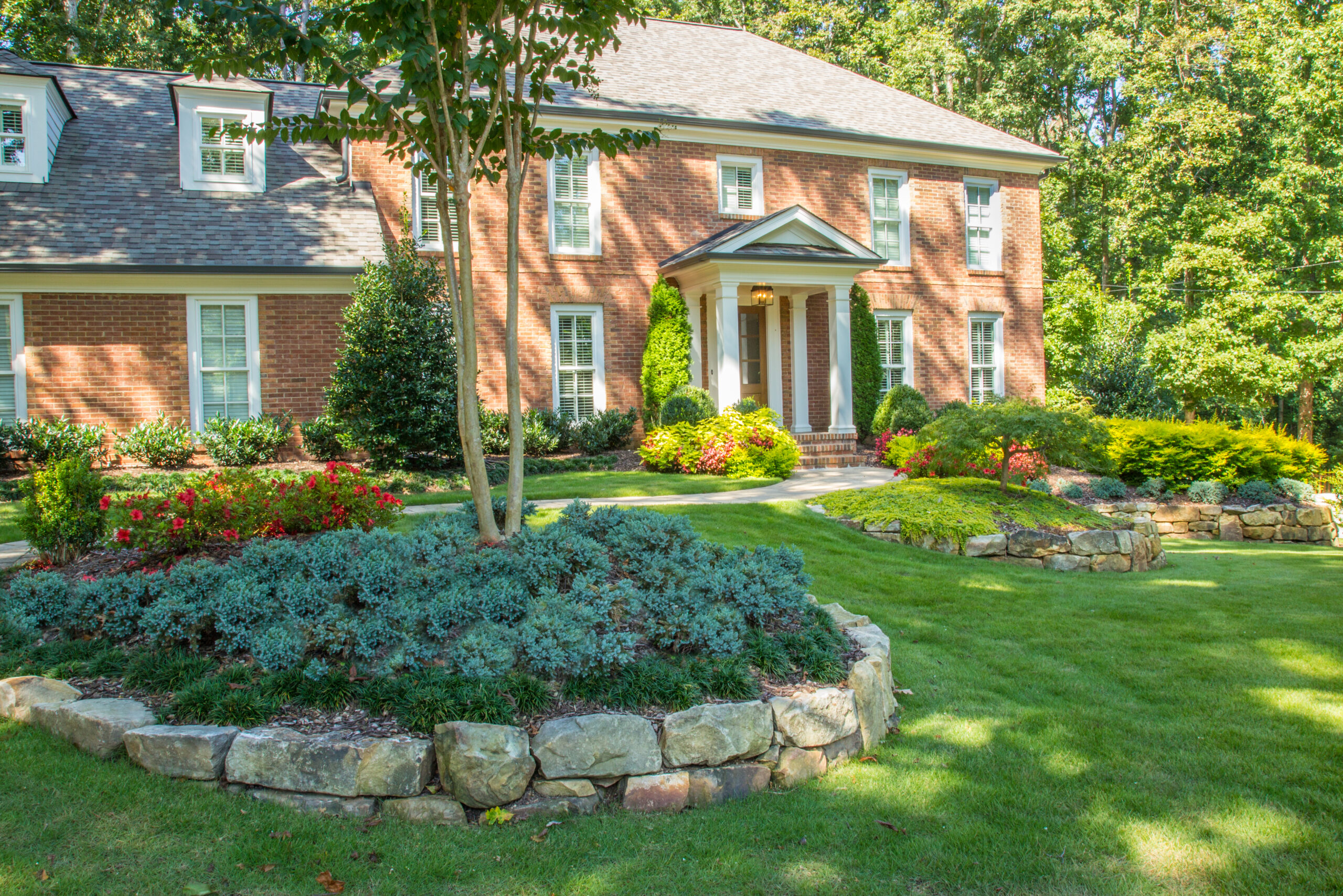 A view of a brick house with greenery