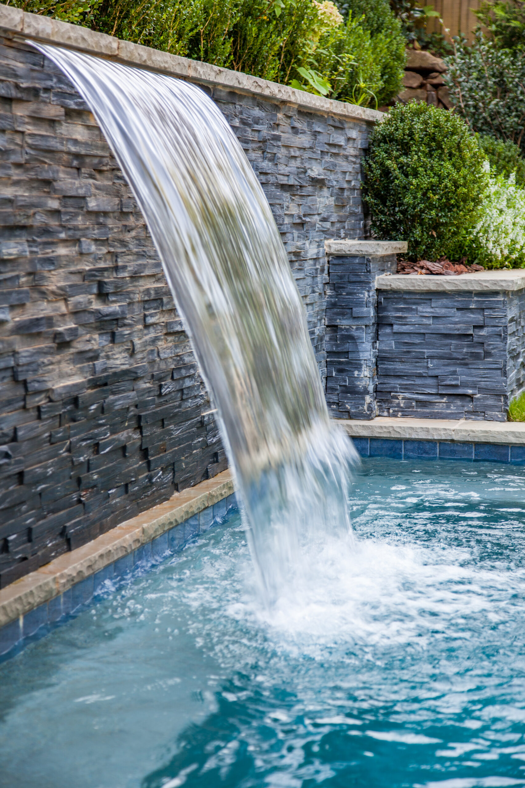 a beautiful fountain running into a pool